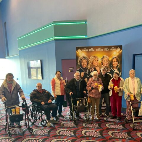 Elderly residents on a group outing at the movies