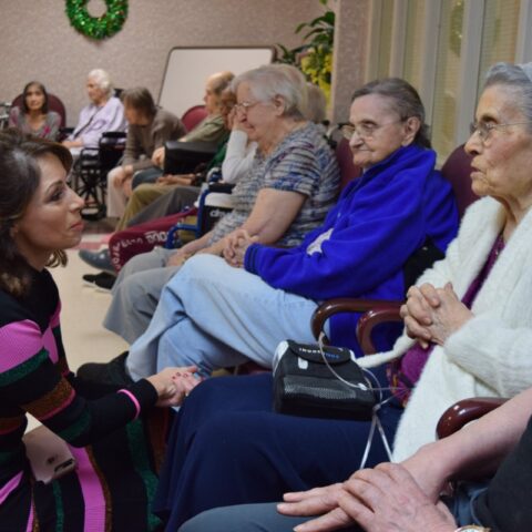 Elderly resident enjoying a visit from a dog, during the Healing Power of Pets event